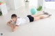 A woman laying on the floor with a blue ball.