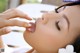 A woman is licking her tongue with her fingers.